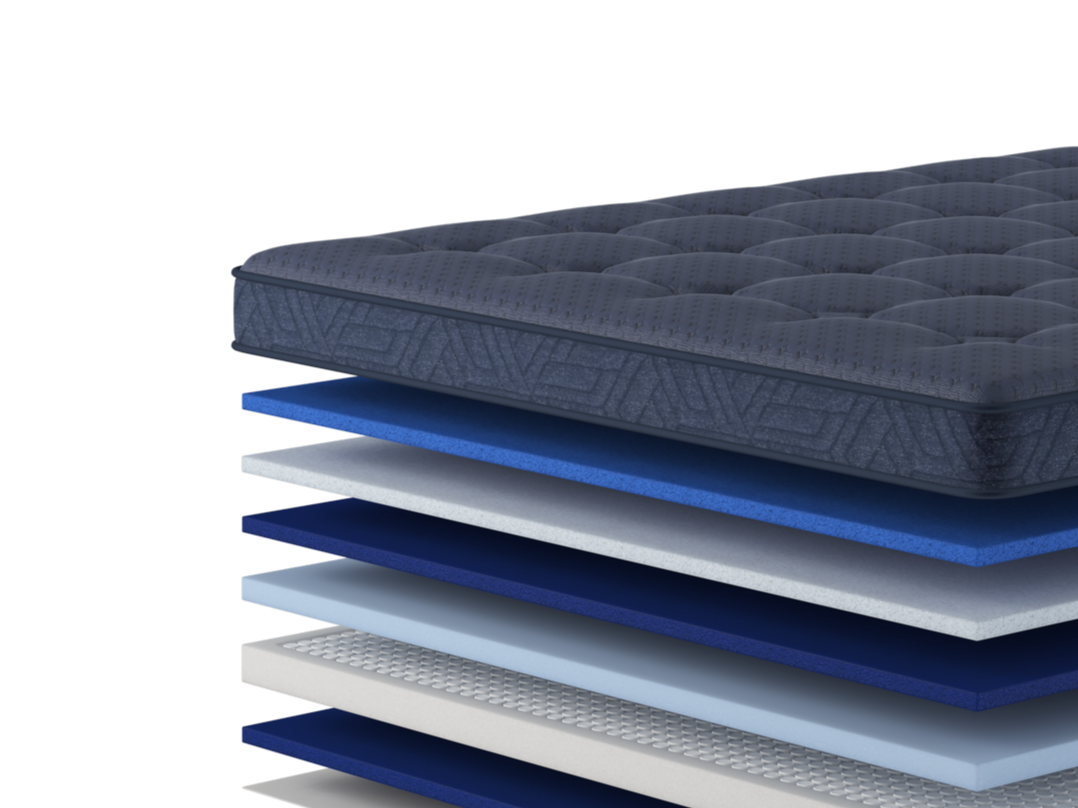 Stacked layers of different mattress materials in shades of blue, gray, and white.