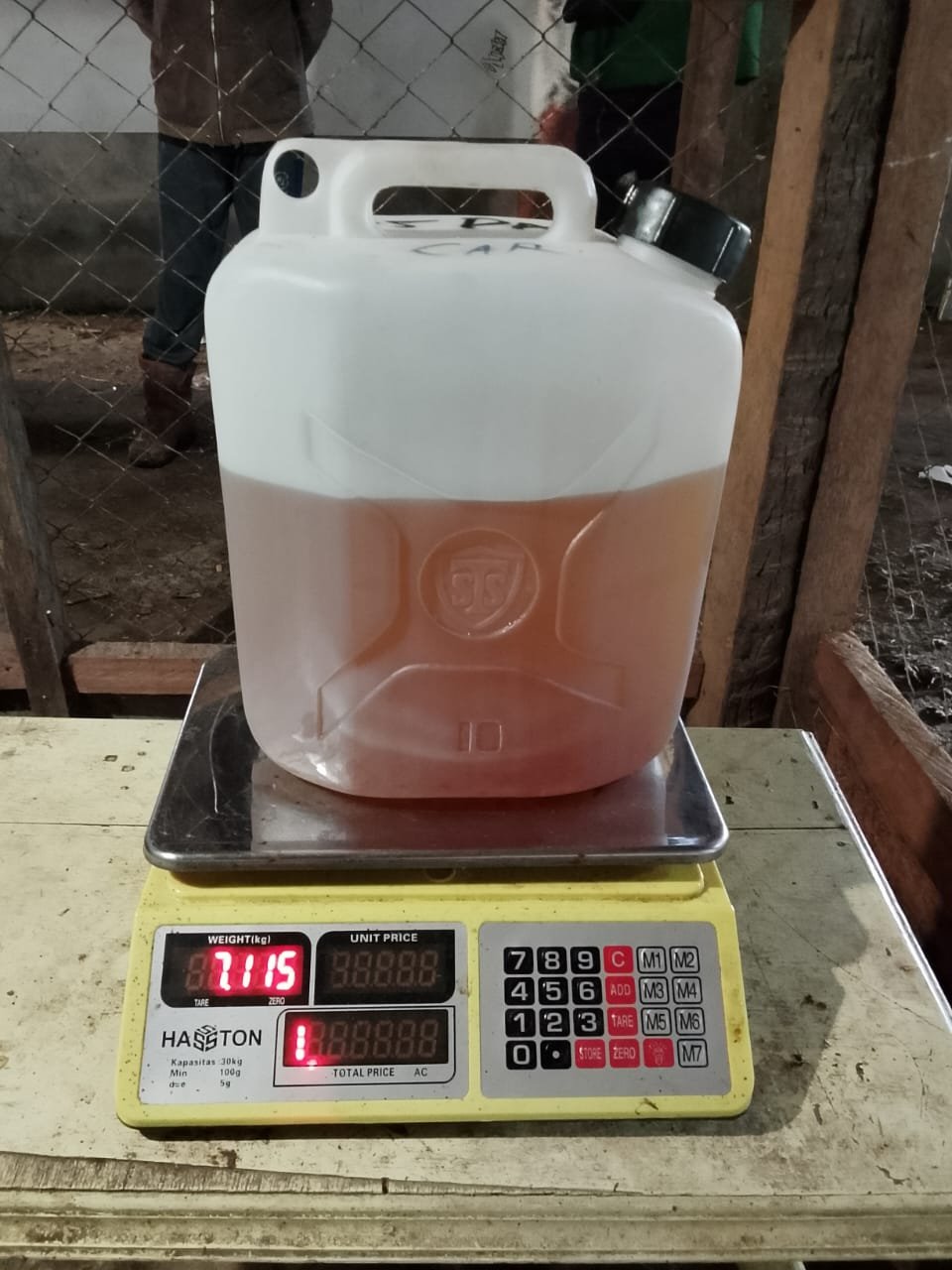 Verifikasi kuantitas transparan jerigen Minyak Nilam murni 7,115 kg sebelum proses pengemasan akhir untuk pelanggan.