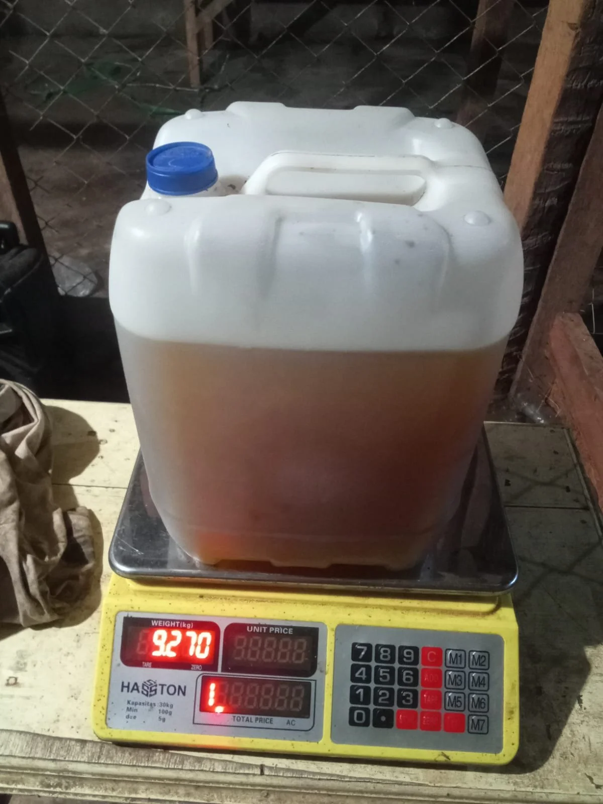 Penimbangan akurat Minyak Nilam murni RUMEVA seberat 9,270 kg menggunakan timbangan digital untuk menjamin ketepatan volume pengiriman.