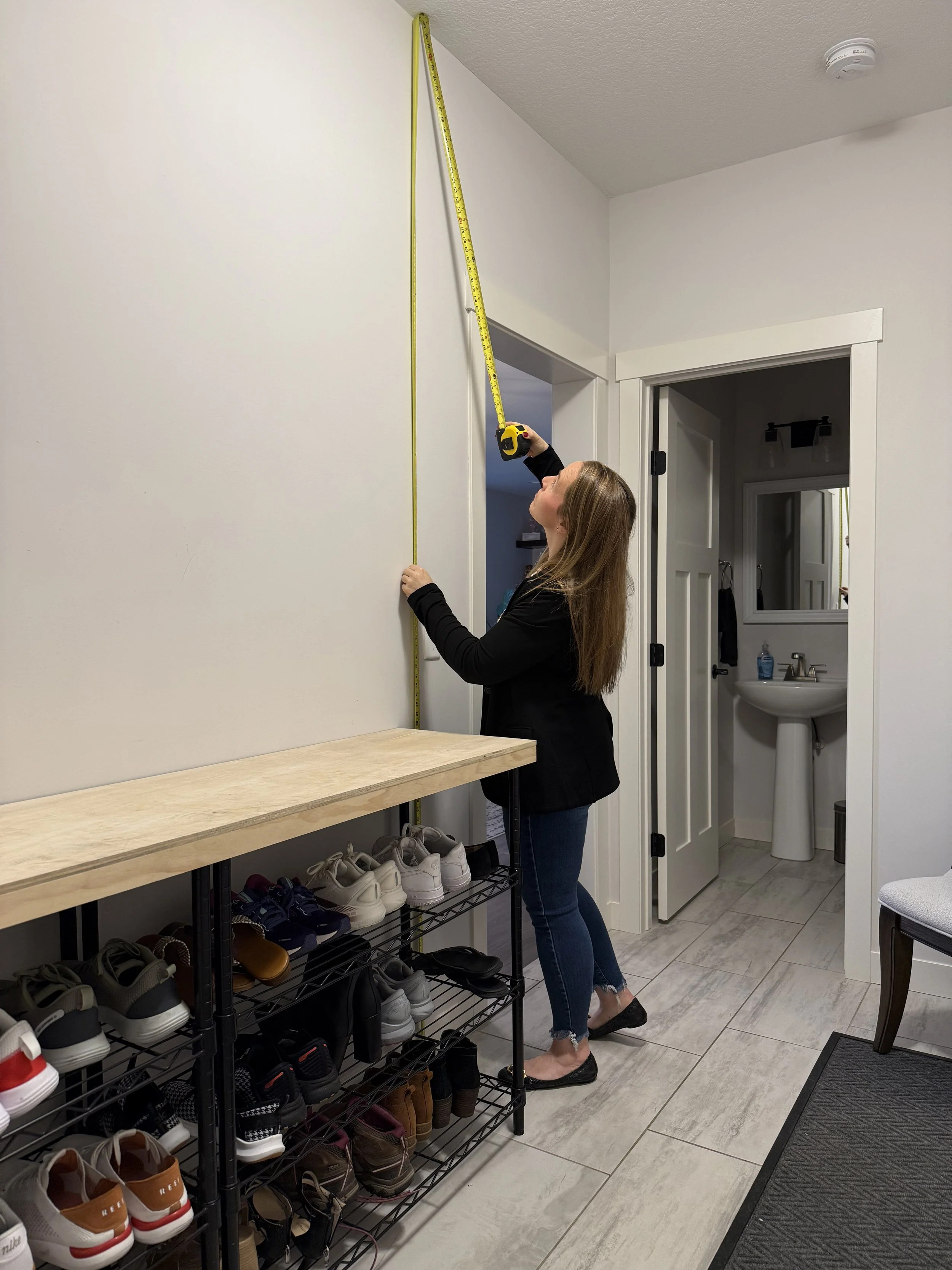 Ashley measuring a space during an in-home organizing consultation in Rochester, MN