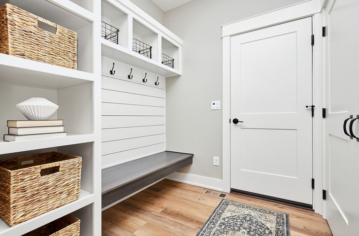 Custom mudroom storage bench with built-in shelving and organization system in a Rochester, MN home