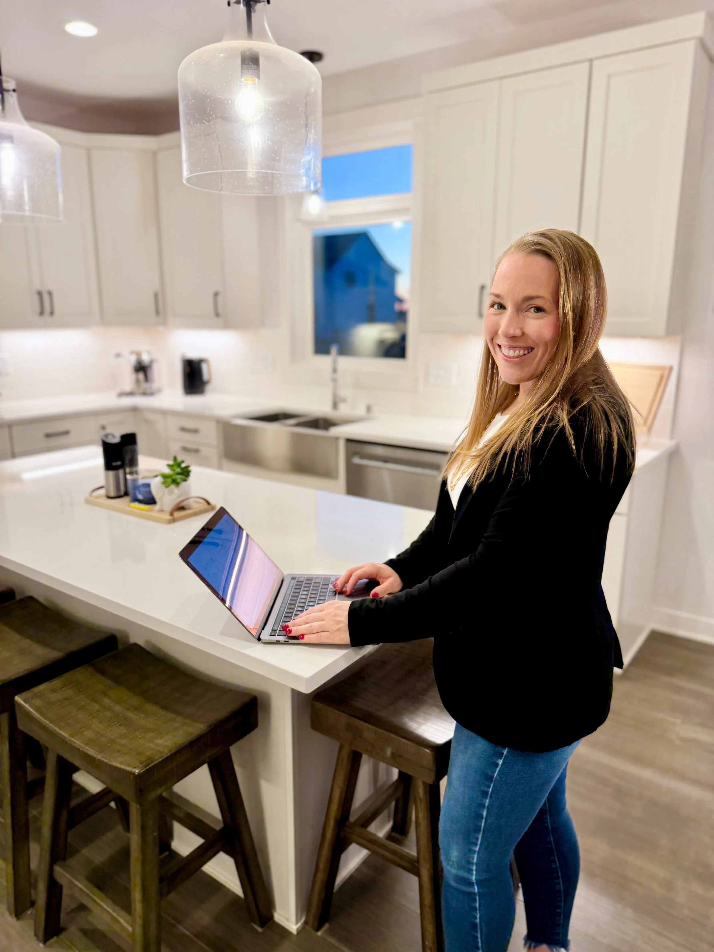 Photo of Ashley in front of a clean and organized kitchen