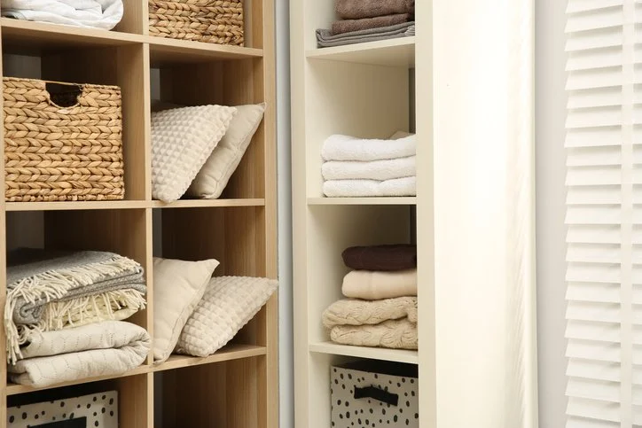 Organized linen closet with folded towels and storage baskets in a home in Rochester, MN