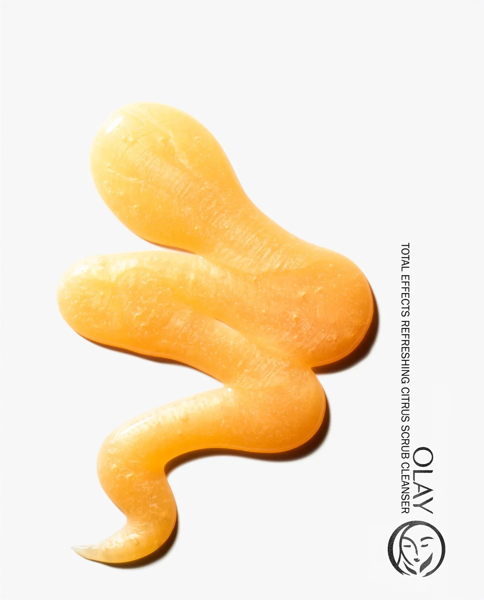 A stylized squiggle of golden gel is shown on a white background with a crisp shadow to represent the texture of Olay Refreshing CitrusScrub