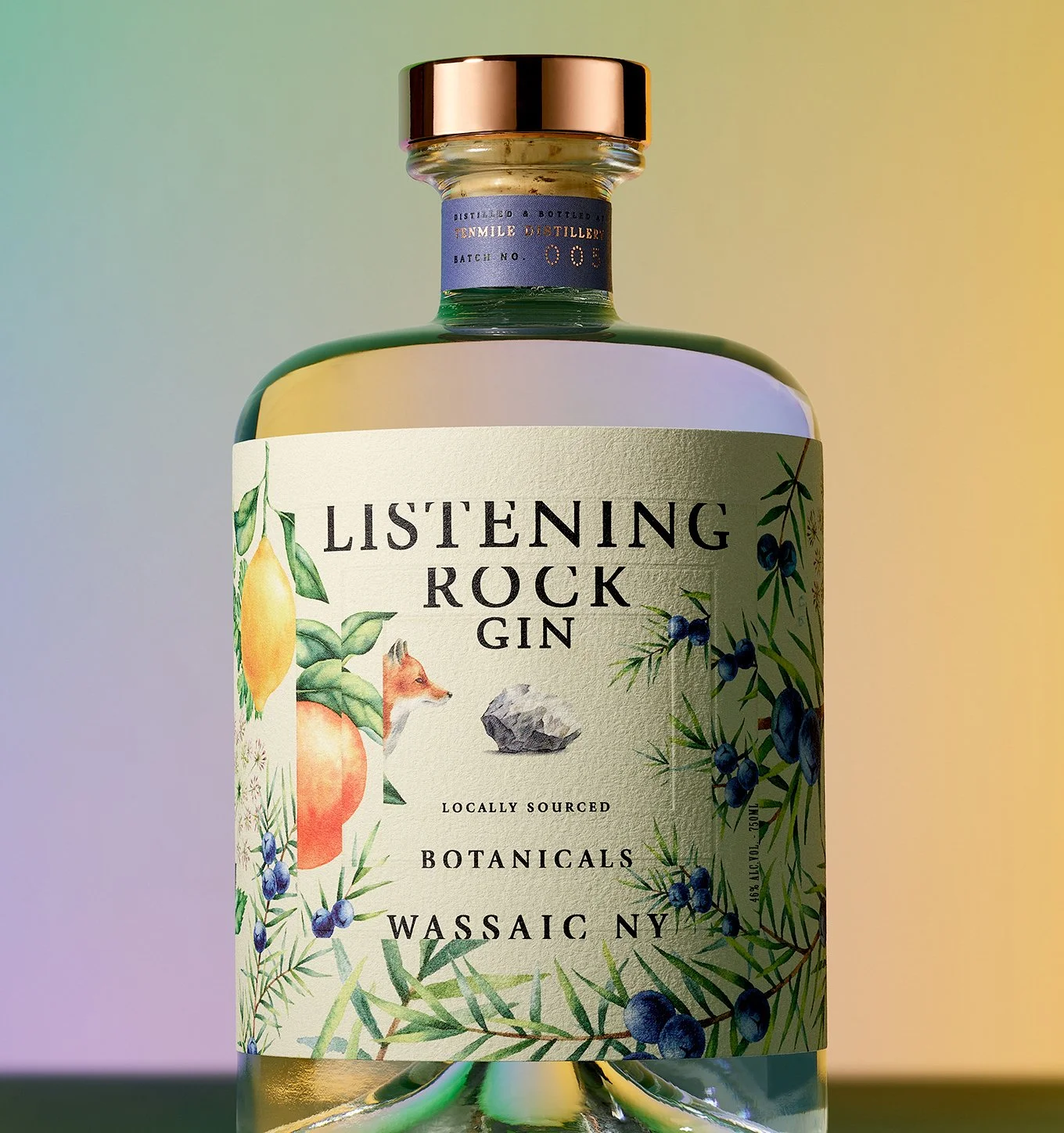 A bottle of Listening Rock Gin with botanical illustrations of lemon, apple, blueberries, and green foliage on the label, set against a colorful gradient background.