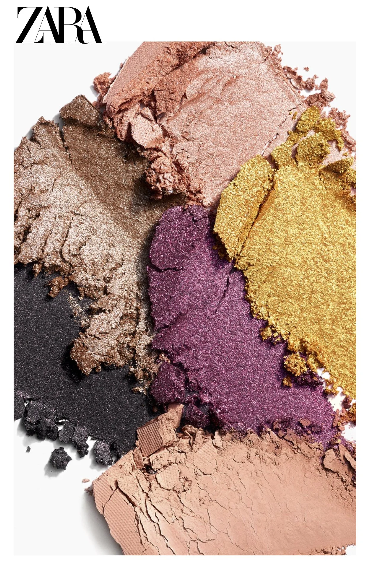 A group of six eyeshadow colors some metallic, some matte overlap in a tight composition on a white surface
