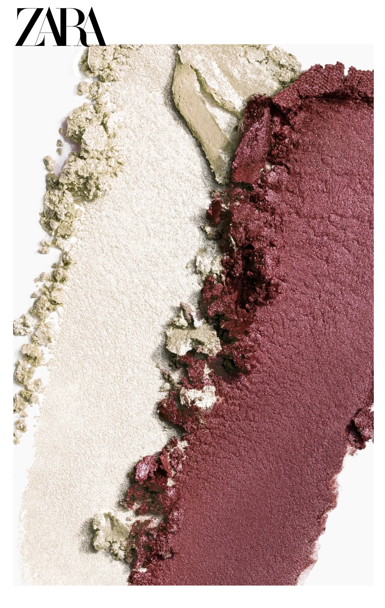 A set of two eyeshadow colors, one white, one burgundy overlap in a tight composition on a white surface
