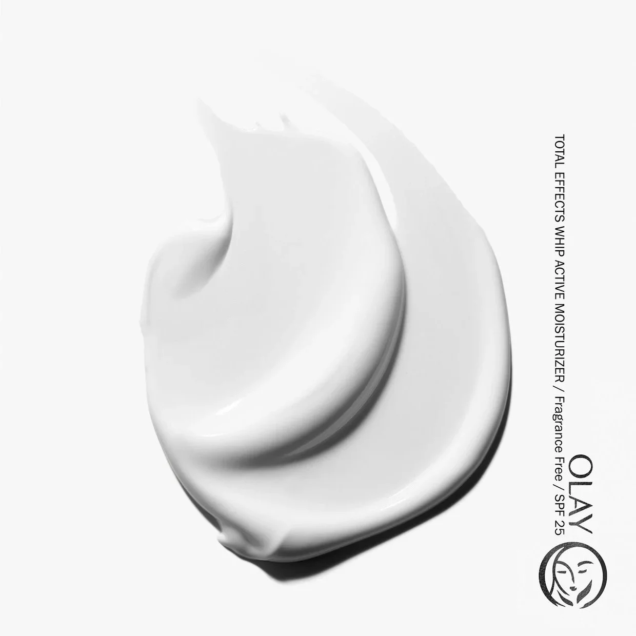 A stylized swoosh of white cream is shown on a white background with a crisp shadow to represent the texture of Olay Total Effects Whips