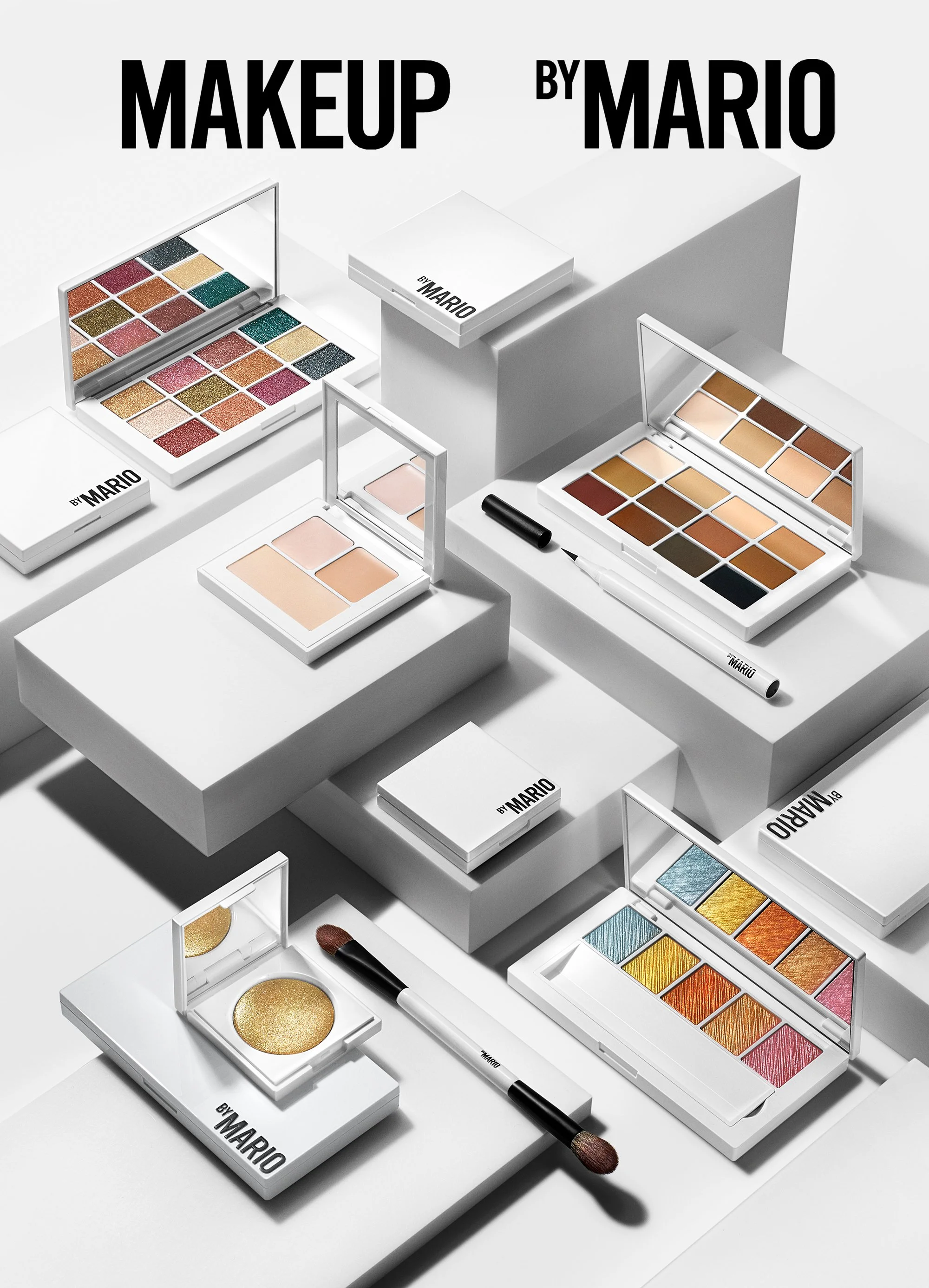 Makeup palettes and brushes are arranged in a graphic geometric composition on white rectangular plinths and a white background with crisp shadows