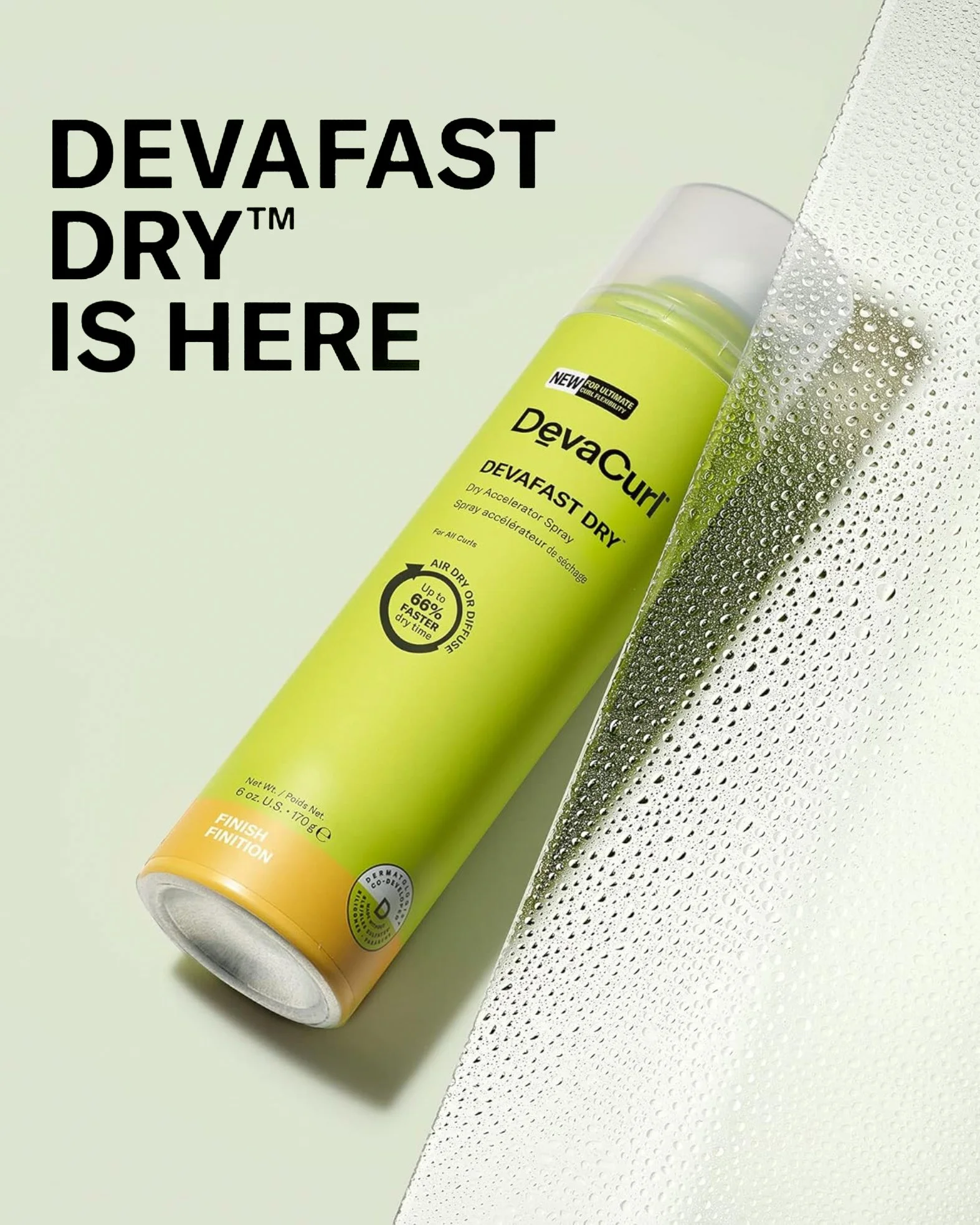 A cylindrical green spray bottle of haircare product lays on a pale green surface next to a panel of water droplets