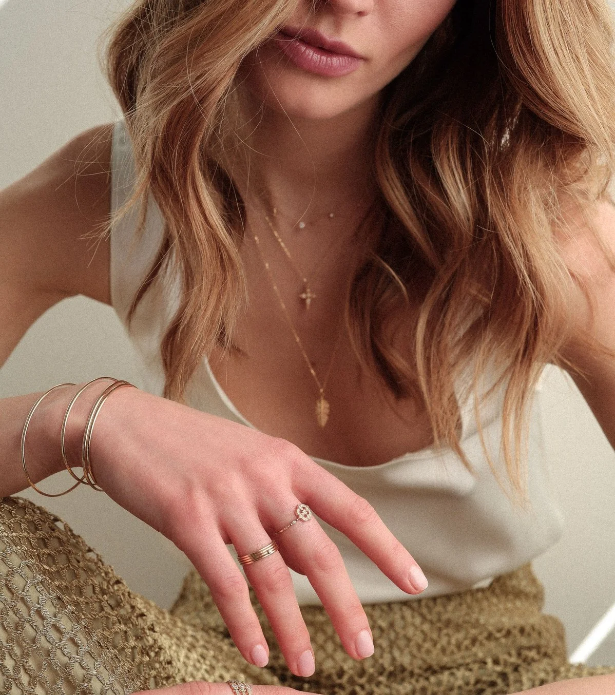 Angele Brousse gold jewelry necklaces and rings on model