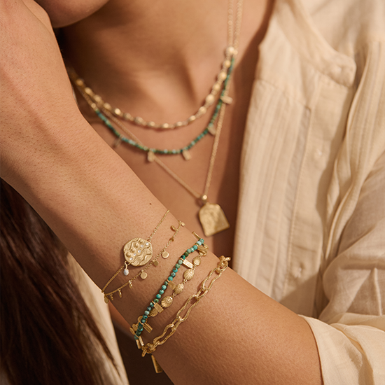 Murkani gold and turquoise jewelry on model