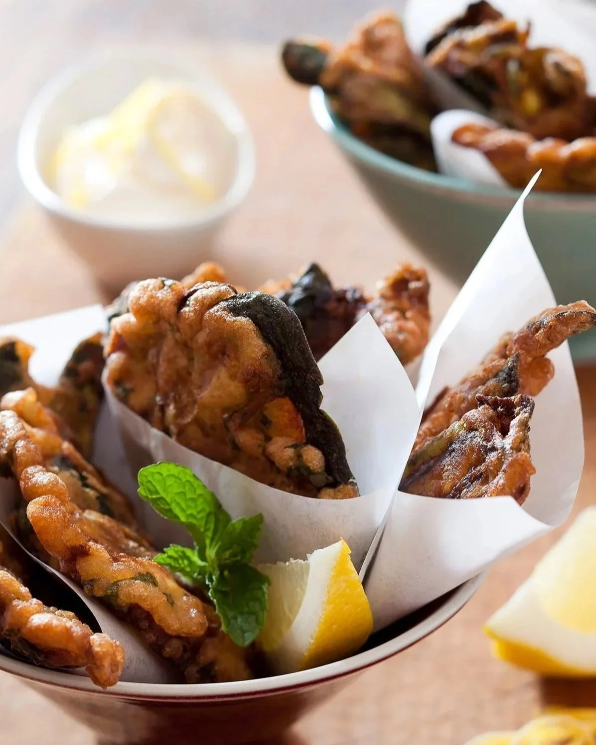 eggplant fitters in bowl with lemon and mint
