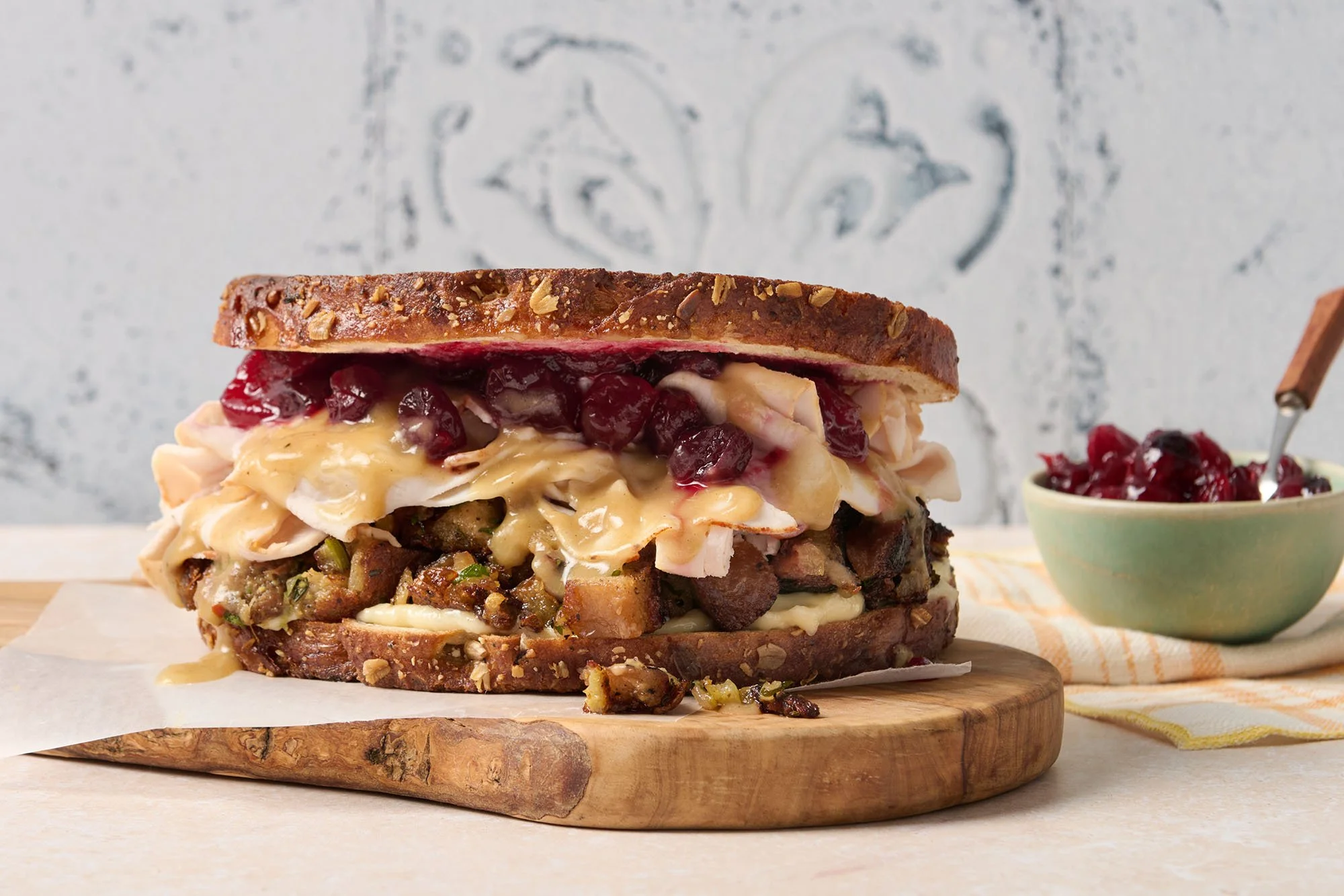 turkey gobbler sandwich with cranberry relish on wood tray
