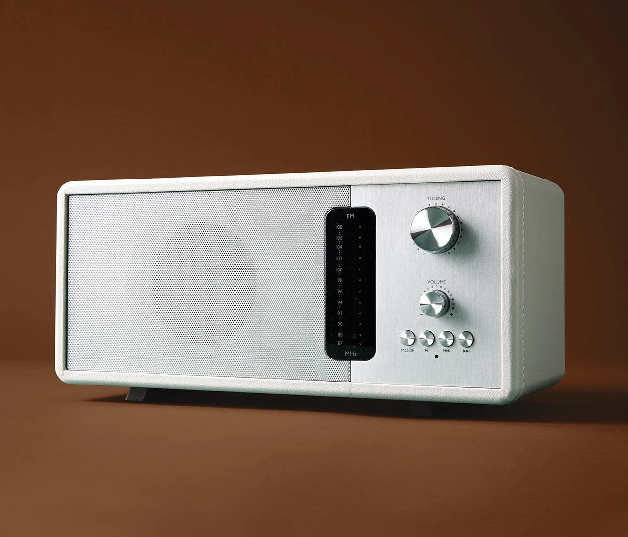 modern, vintage design inspired white radio on brown studio background