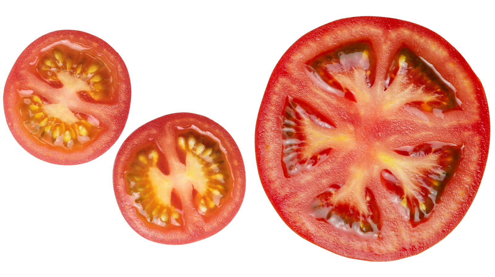 Three fresh tomatoes cut in half, two small and one large, showing the red flesh, seeds, and inner structure.