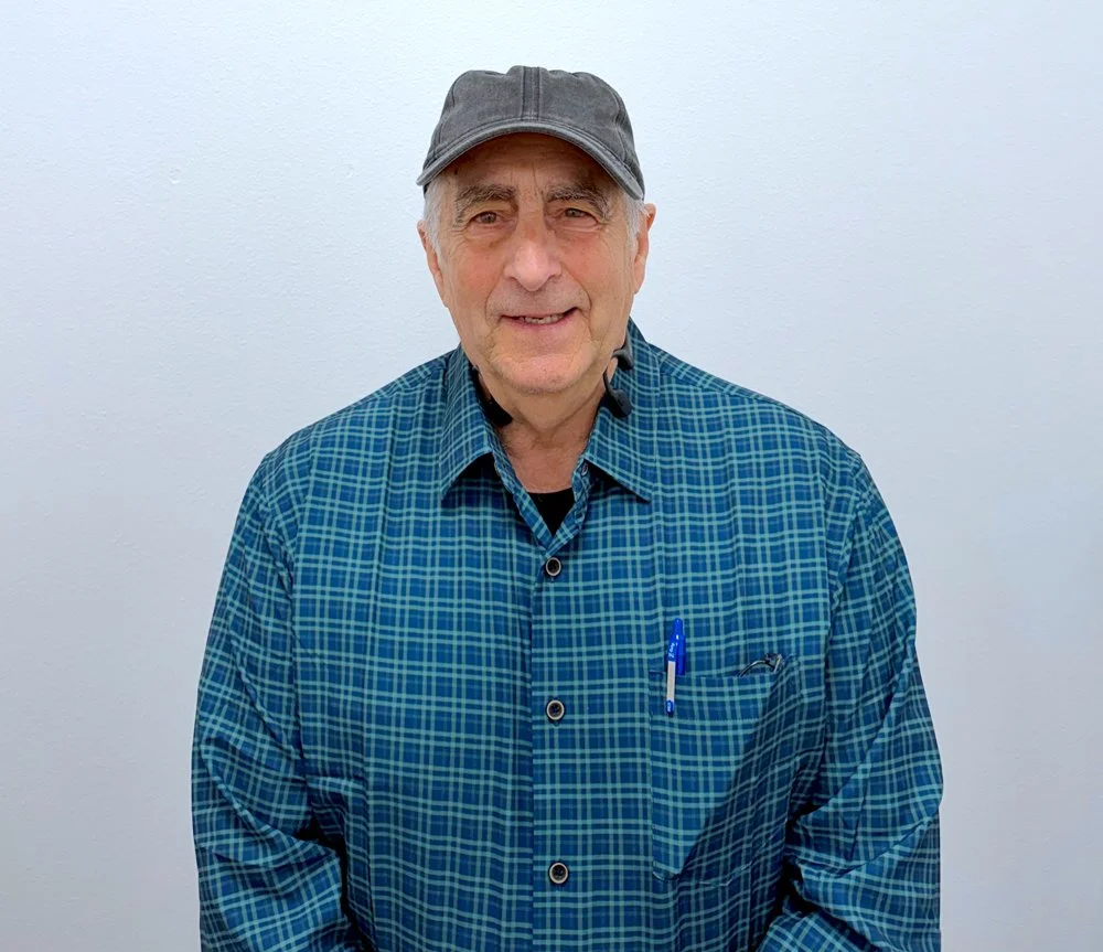 Man with a hat in a blue plaid shirt