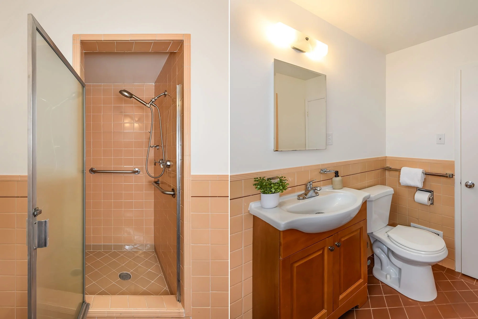 Bathroom with a walk-in shower on the left, and a vanity with a sink, mirror, and toilet on the right. The shower has peach tiles and grab bars, and the bathroom features peach tile wainscoting.