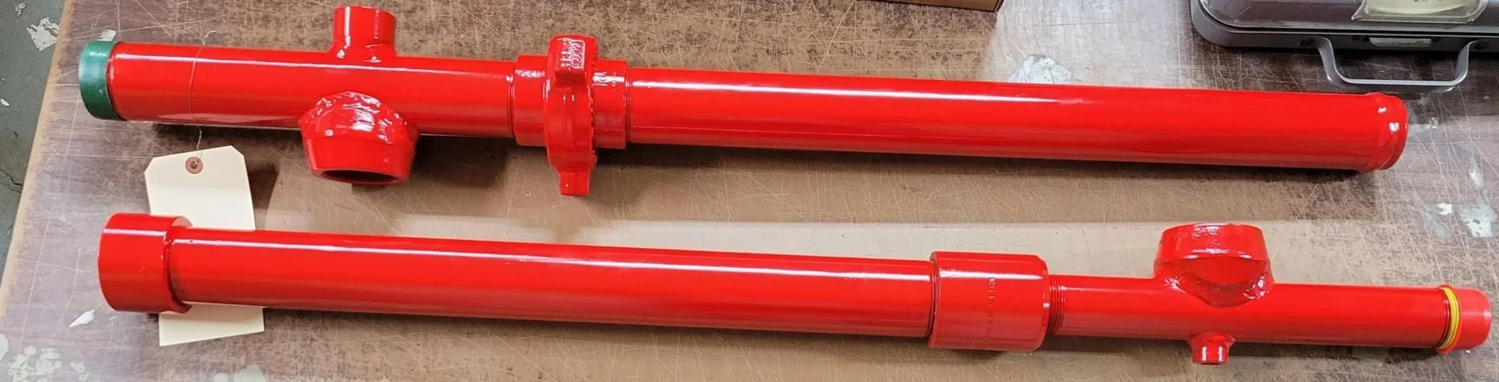 Two red TPS Lubricators