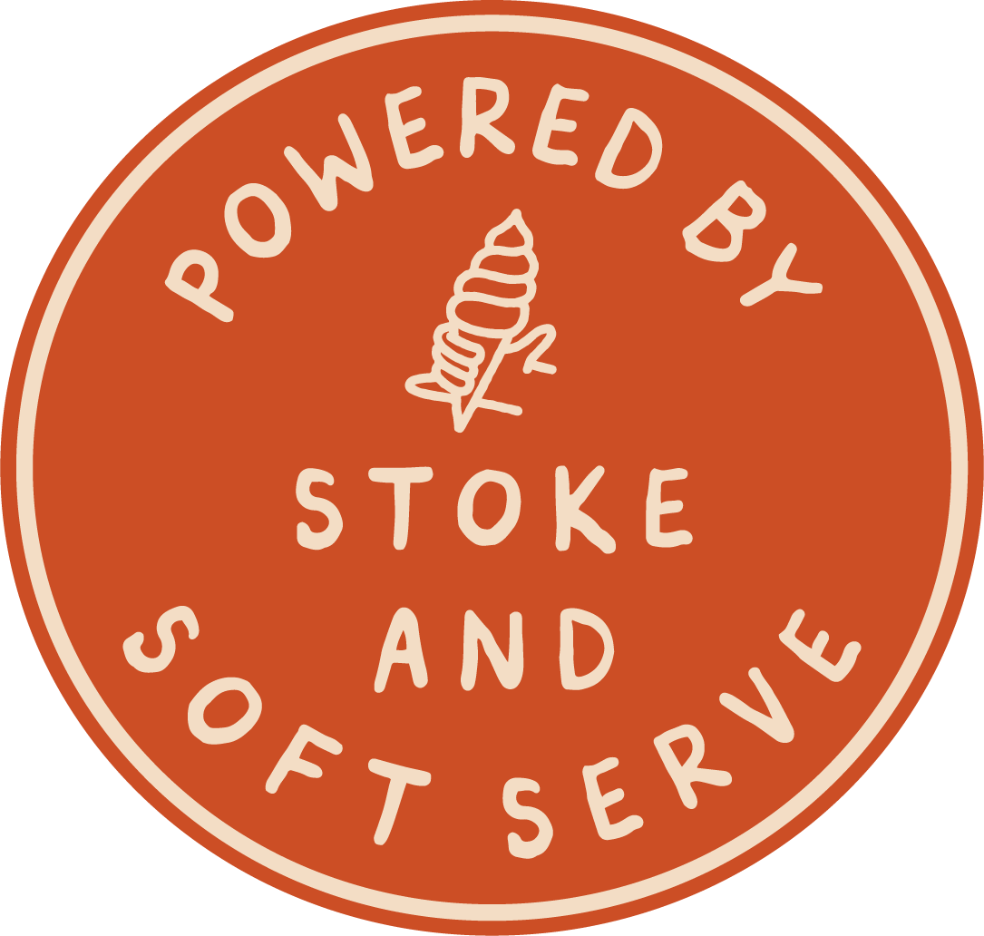 Circular logo with a terracotta background and cream-colored border. Text reads "Powered by Stoke and Soft Serve" around the circle, with a stylized swirl ice cream atop a cone in the center.