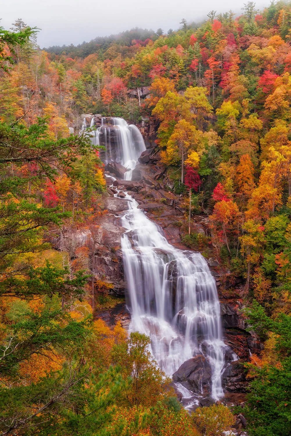 Upper Whitewater Falls in North Carolina surrounded by vibrant fall foliage.