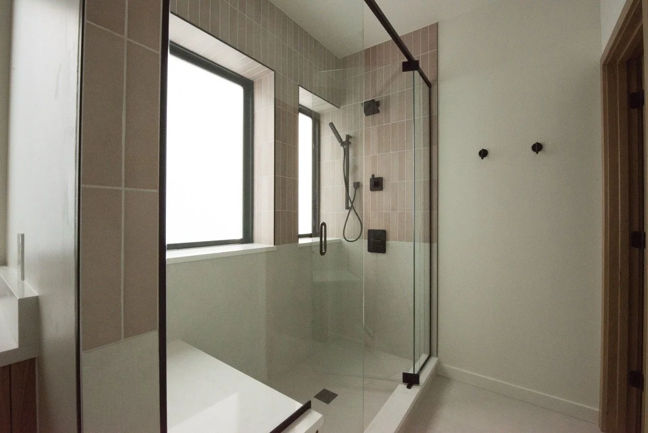 Custom primary bathroom shower and tile in Washington Park home remodel.