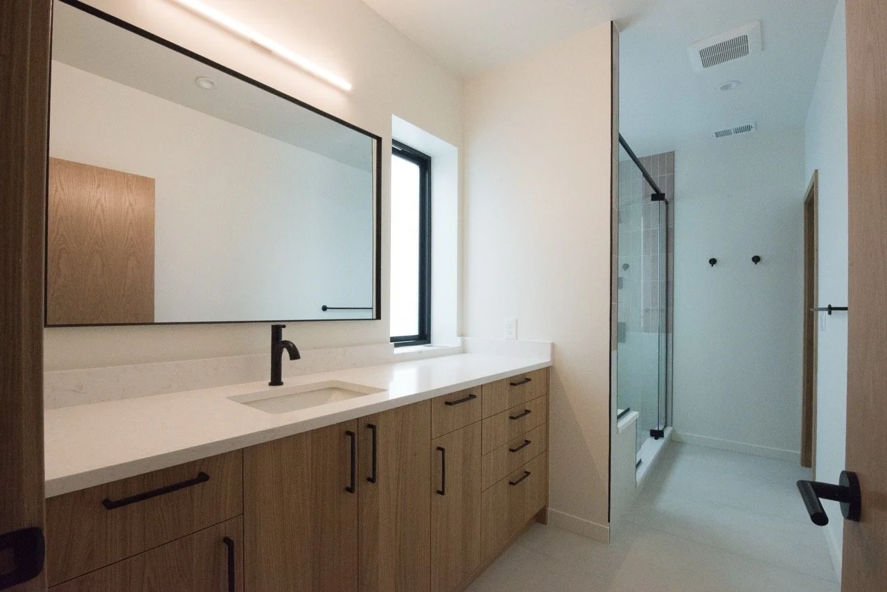 Custom primary bathroom vanity and millwork in a Washington Park home remodel