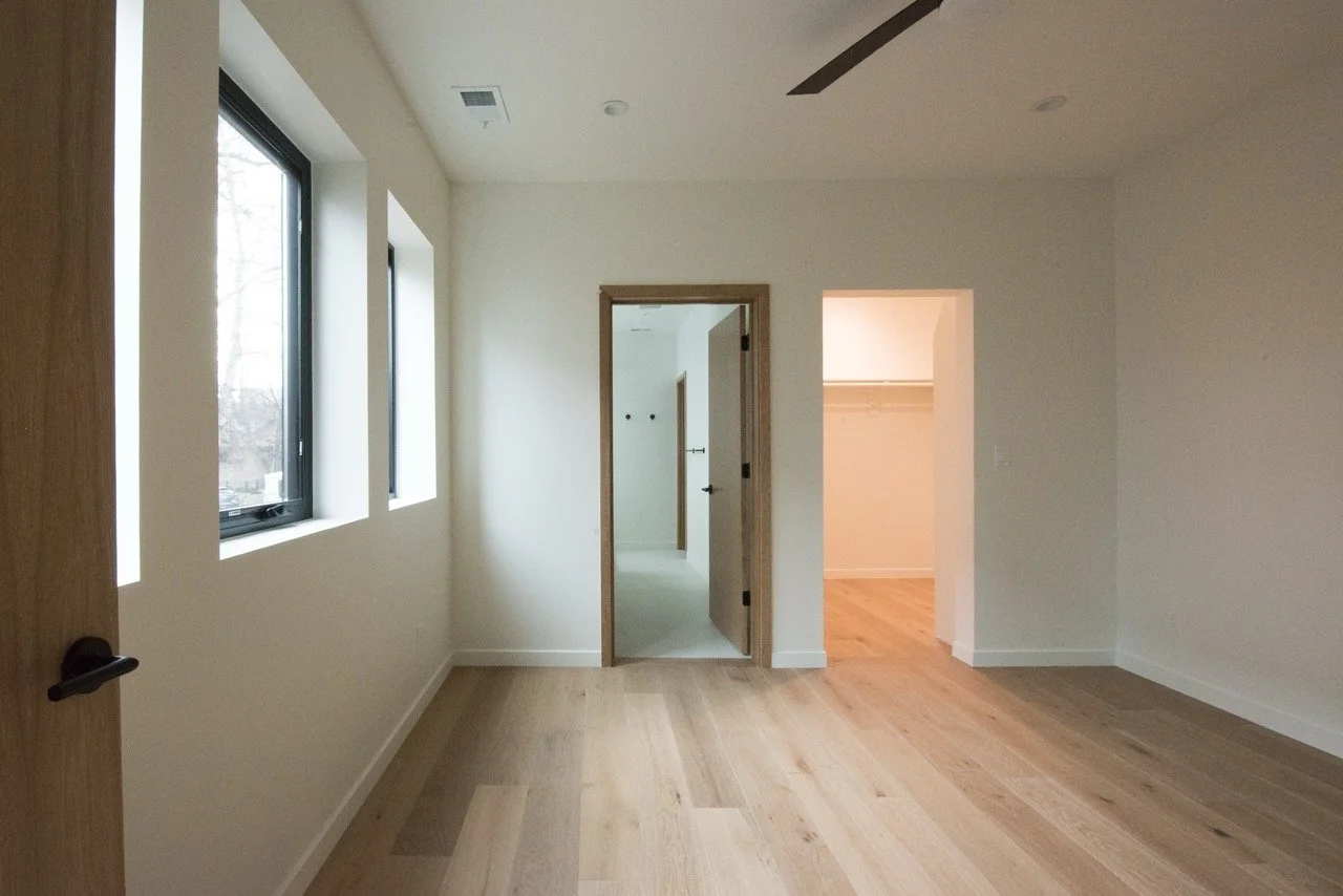 New primary suite with master bathroom and walk-in closet with white oak doors