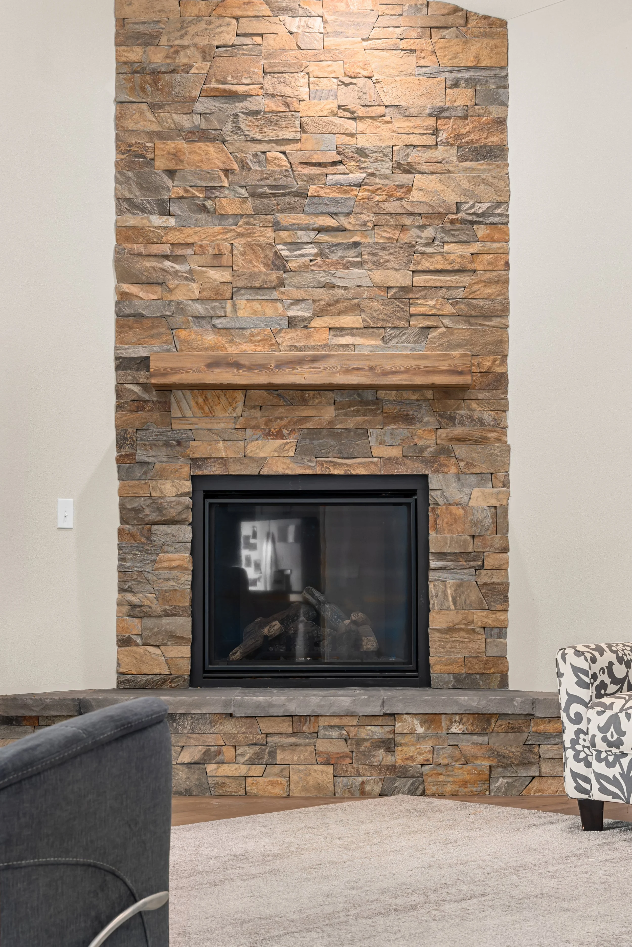 Custom fireplace stone hearth and custom mantle in custom Colorado mountain house.