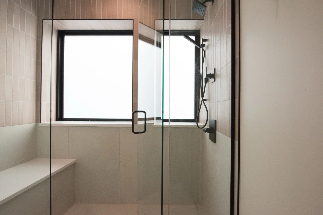 Custom primary bathroom shower and tile in Washington Park home remodel.