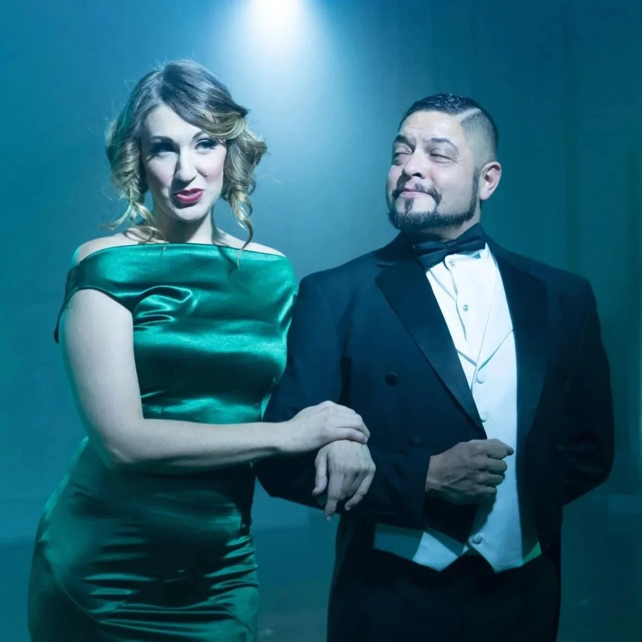 An actor in a formal tuxedo escorts an actress in a green satin ball gown in I Haunt You, an immersive theater show in Eureka Springs Arkansas near Bentonville, Fayetteville, Rogers, and Springdale.