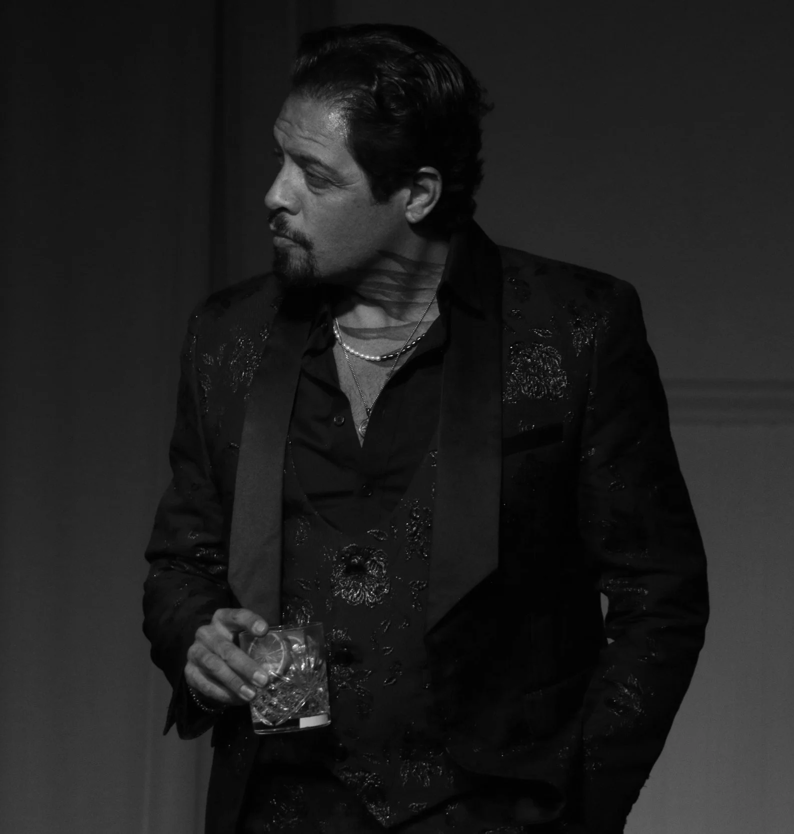 Actor holding a crystal rocks glass in Robbie, an immersive theater show in Eureka Springs Arkansas near Bentonville, Fayetteville, Rogers, and Springdale.