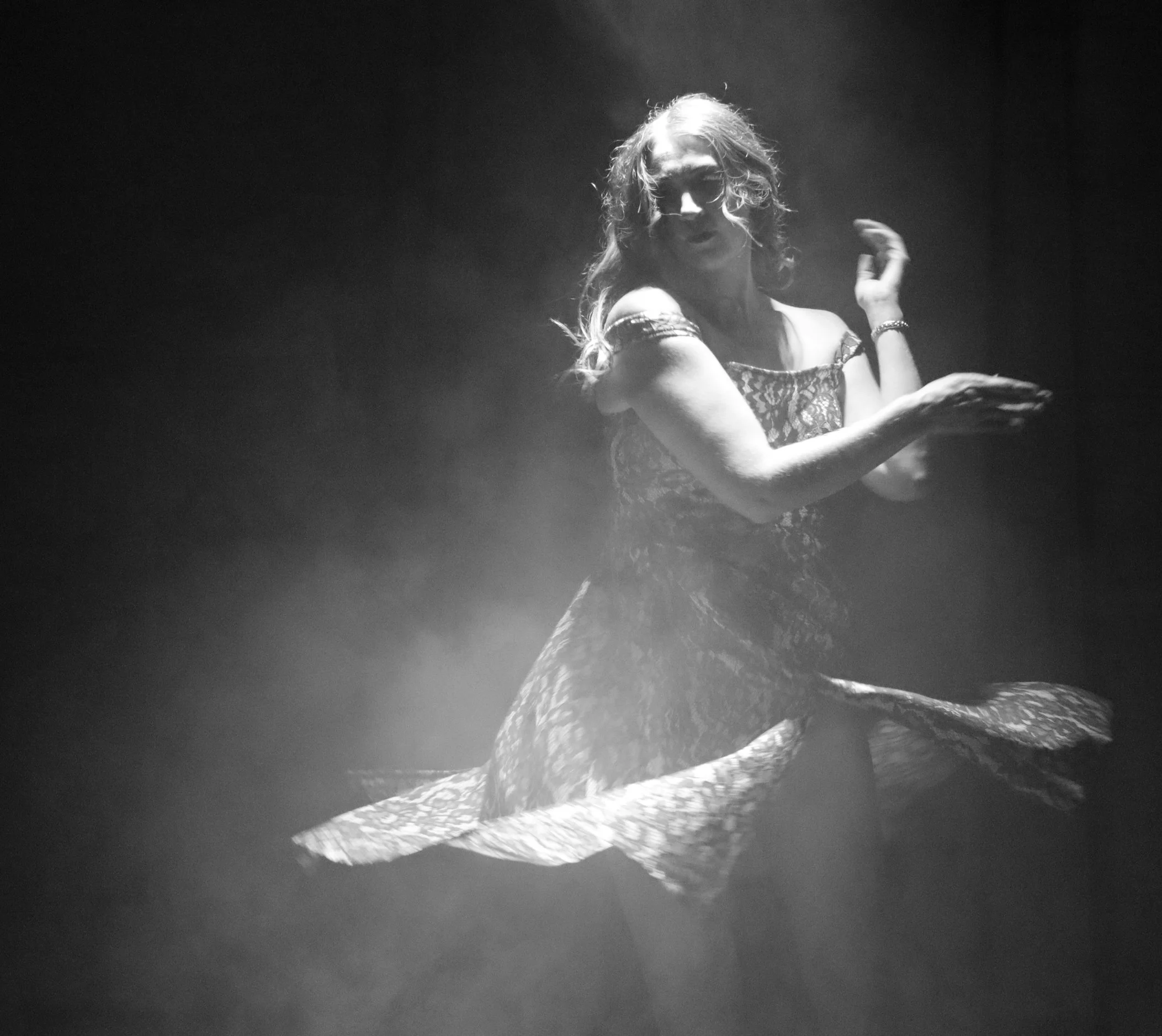 An actor twirling under a spotlight in Robbie, an immersive theater show in Eureka Springs Arkansas near Bentonville, Fayetteville, Rogers, and Springdale.