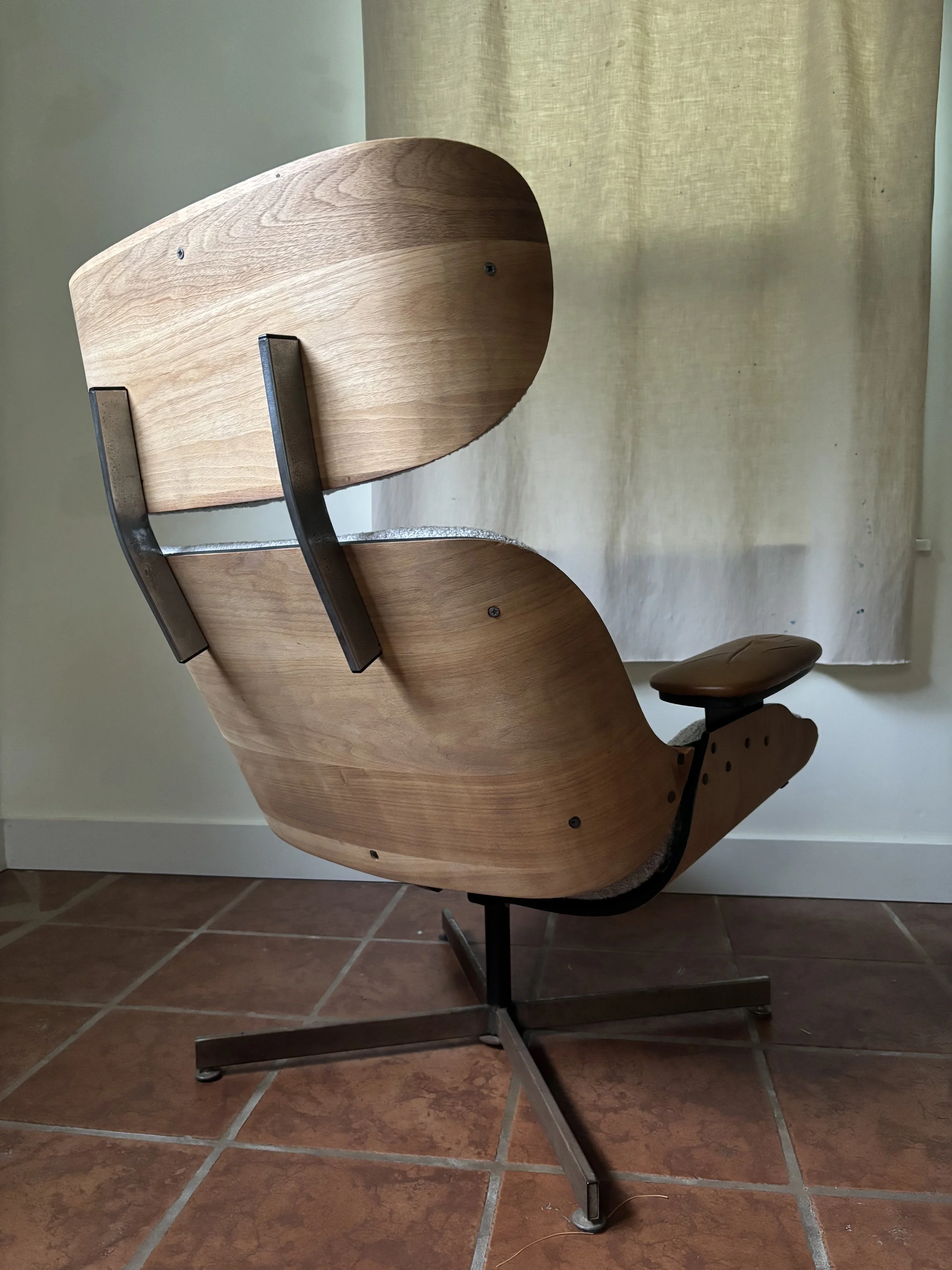reconstructed chair showing curving midcentury panels