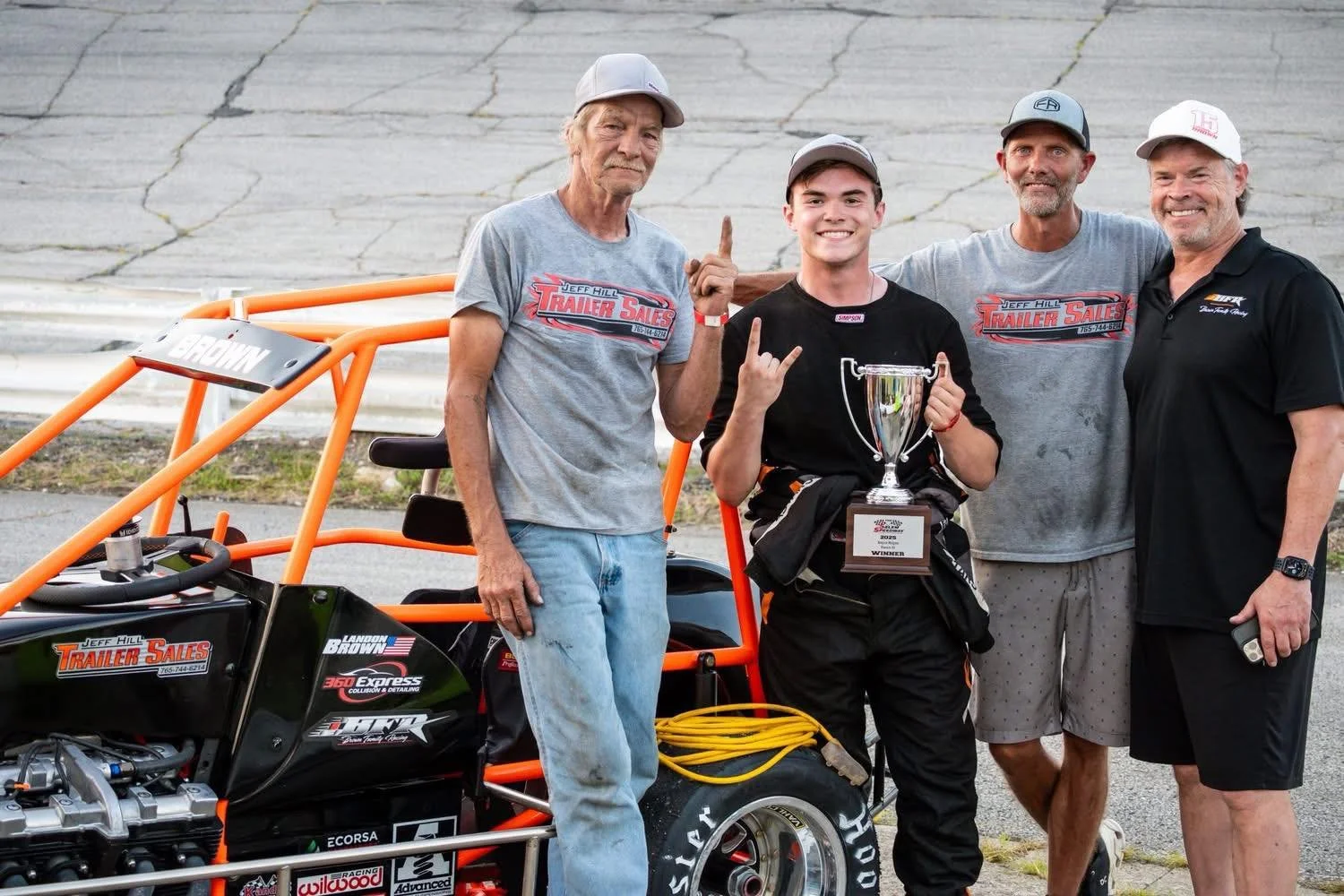 Landon Brown, Phil Brown, David Simmermon and Jeff Trailer Sales Hill holding the winning trophy at Salem Speedway in the Kenyon Midget Series