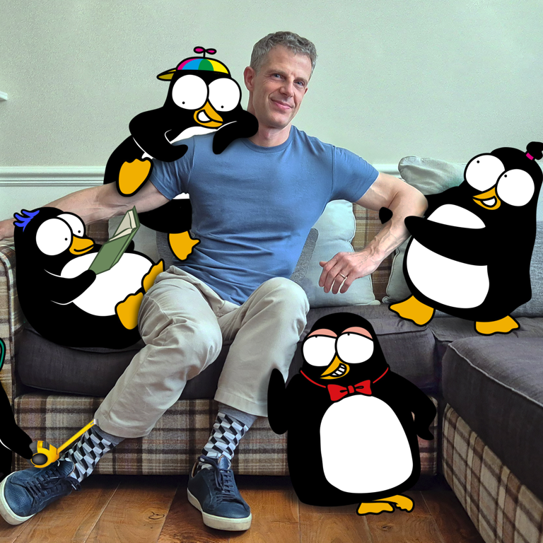 A man sitting on a sofa surrounded by animated penguin characters, some holding a book, wearing glasses, a bow tie, and a hat.
