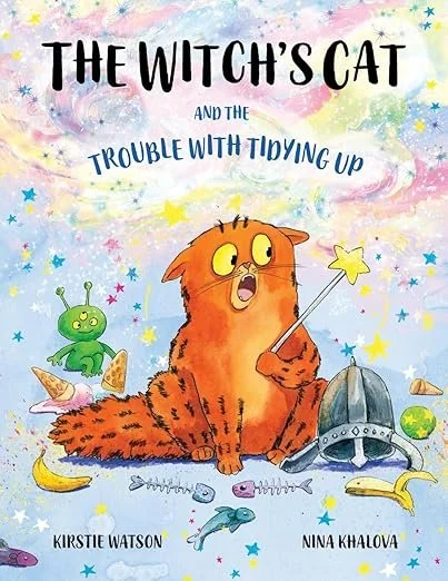 Illustrated book cover for 'The Witch's Cat and the Trouble With Tiding Up' by Kirstie Watson and Nina Khalova, featuring a cartoon orange cat holding a star wand, a small green alien, a helmet, and scattered toys on a colorful background.