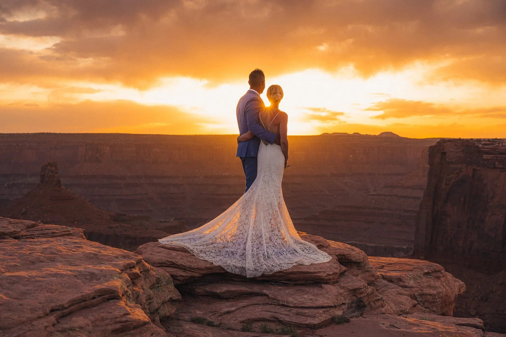 Couple during their desert wedding ceremony on BLM land outside Moab Utah at golden hour