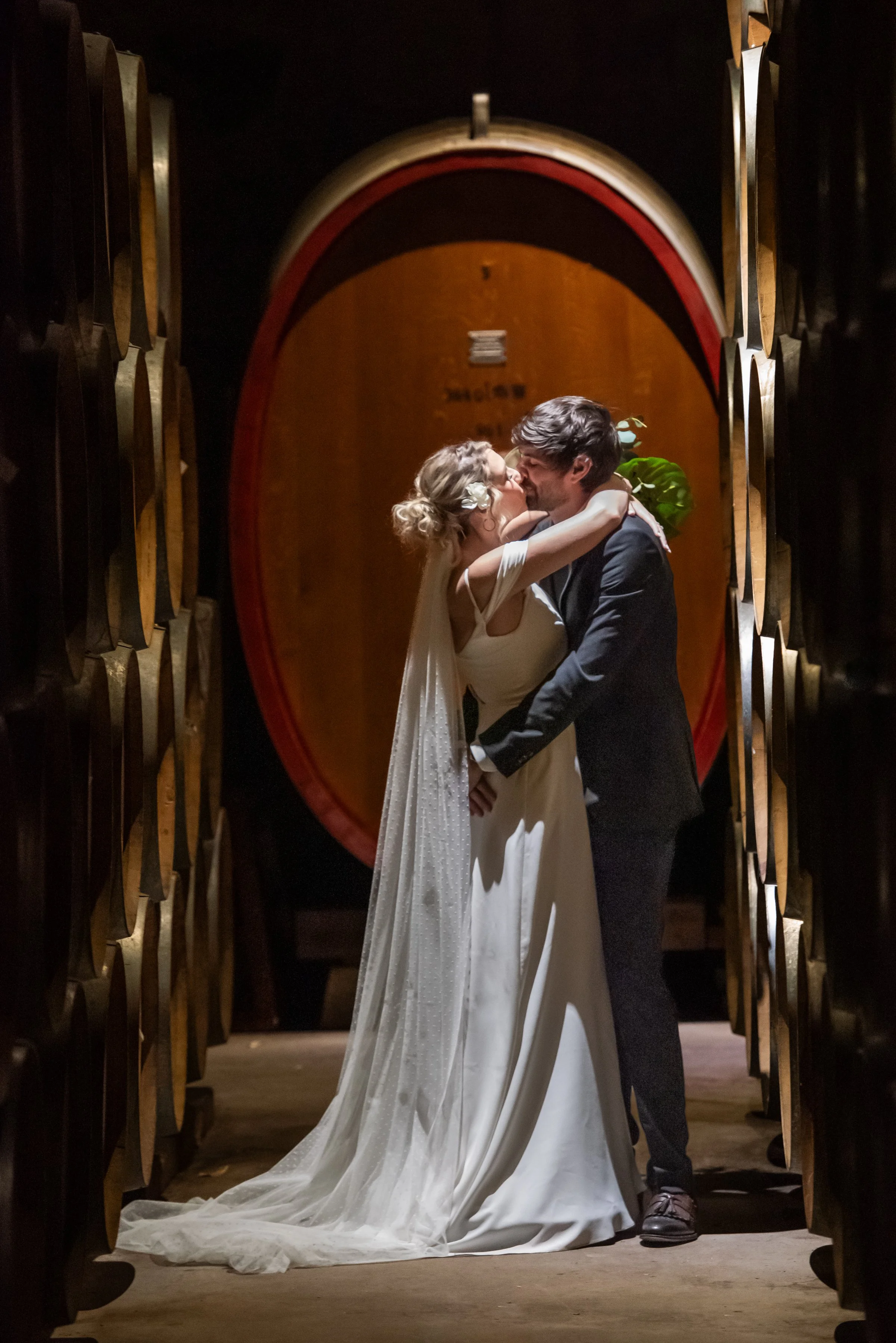 couple kissing in barrel room