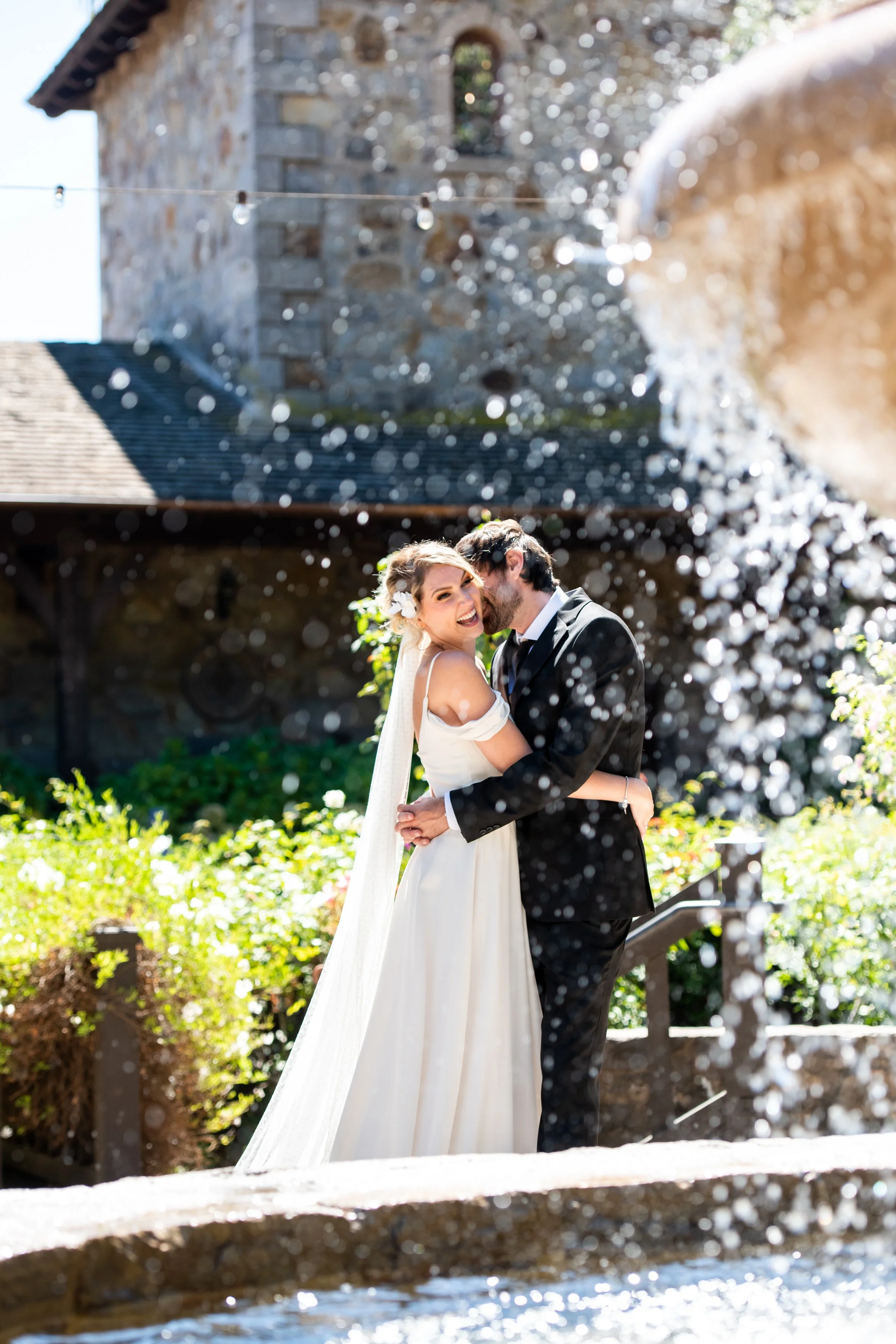 Couple holding each other by fountain