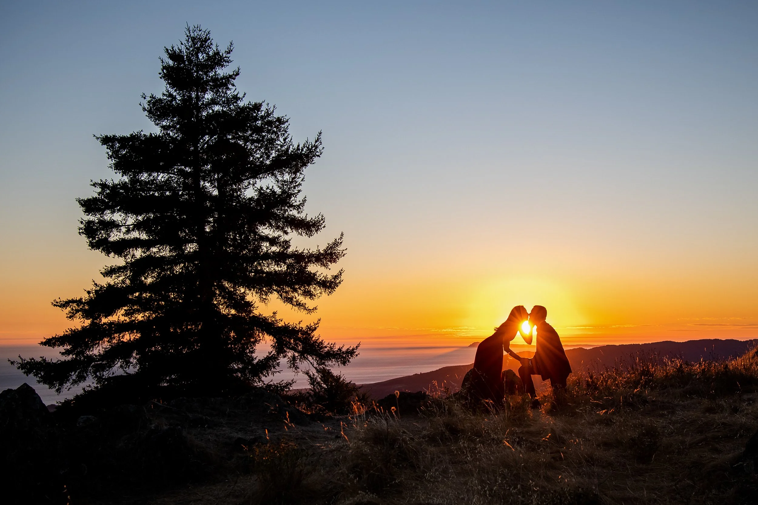 Couple kissing at sunset