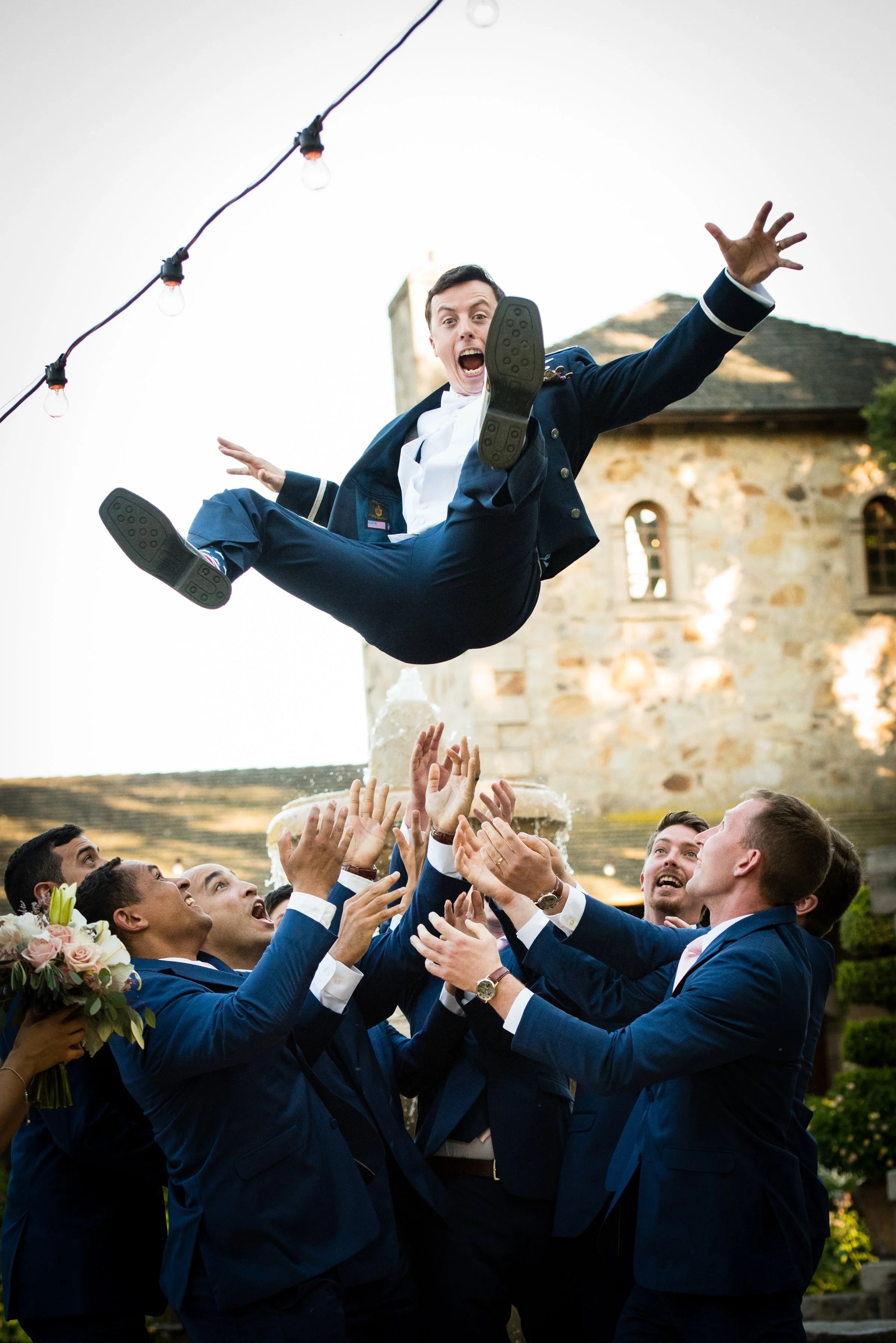 Groomsmen throwing their groom