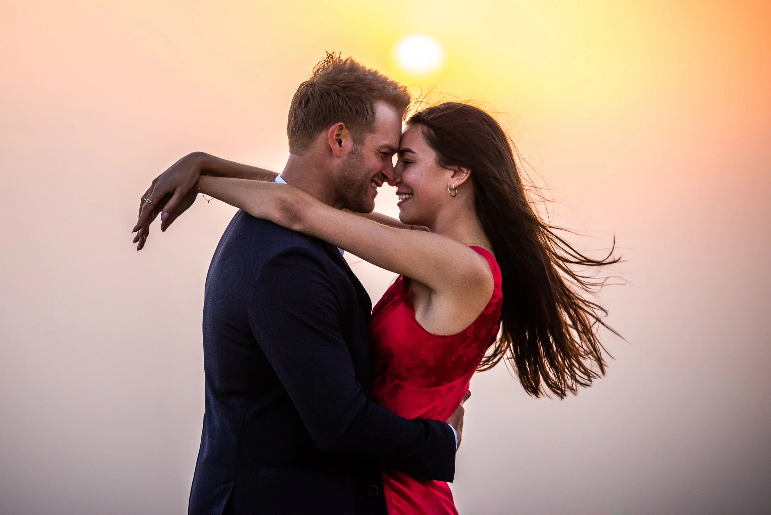 Couple standing close at sunset