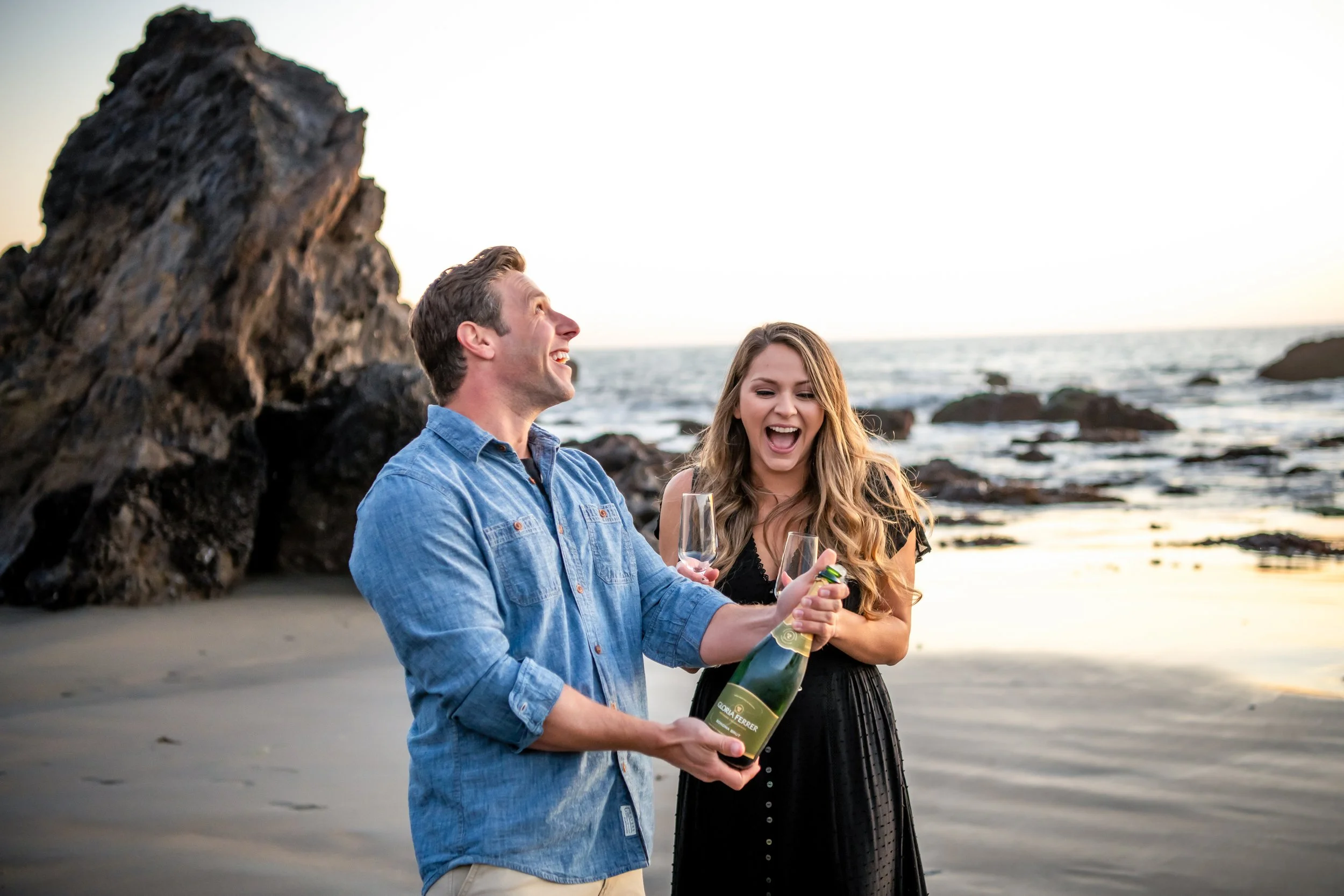 Couple spraying champagne