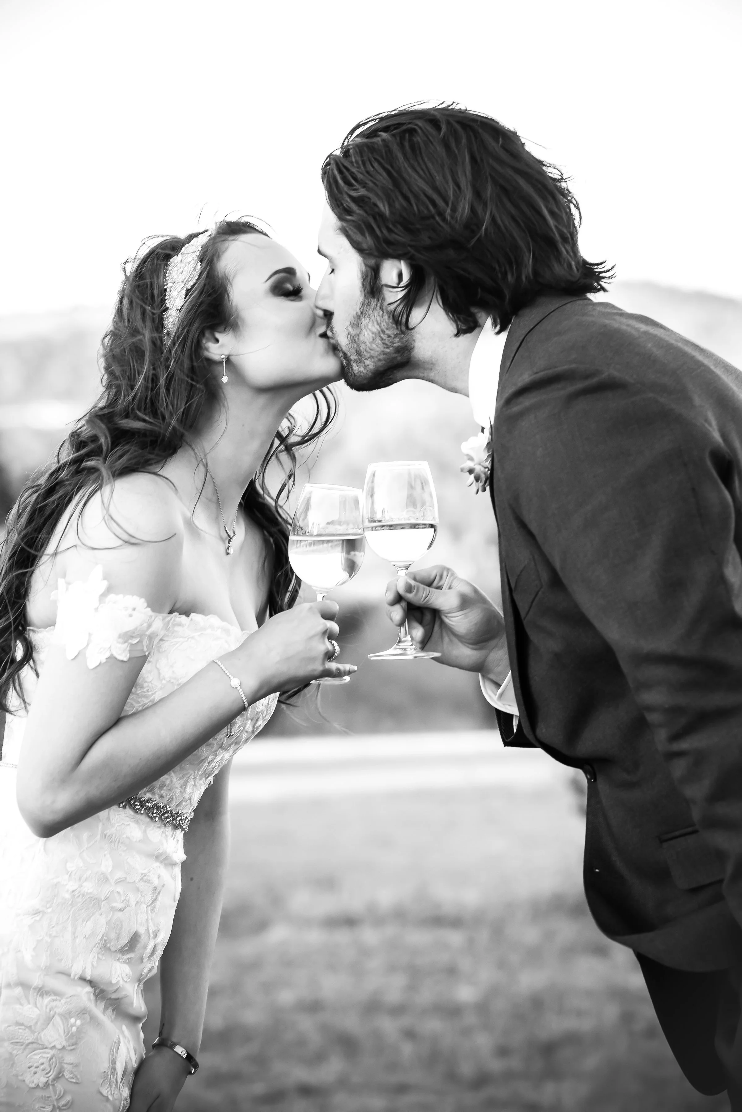 Couple kissing with wine glasses