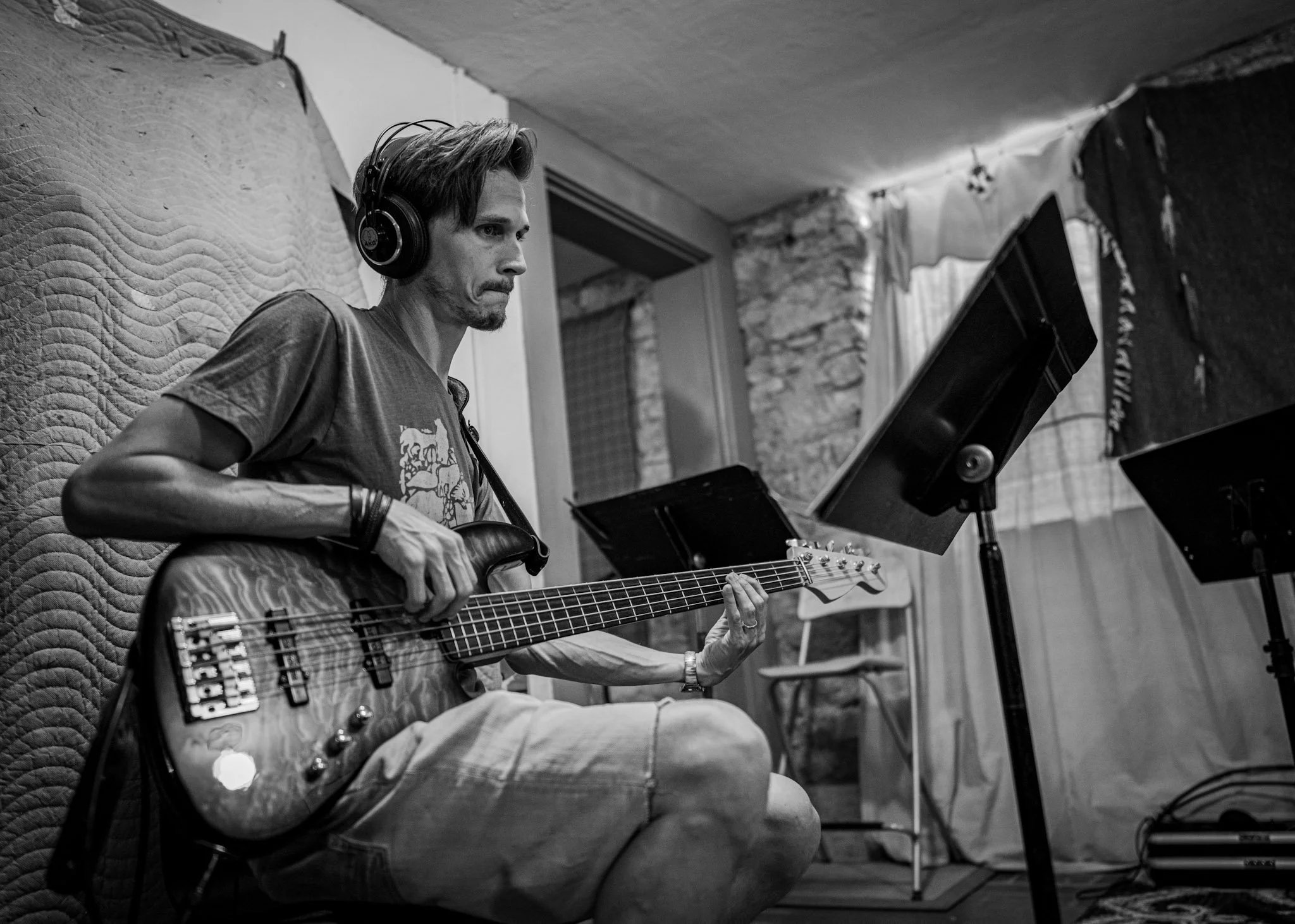 A musician playing electric bass at the Esteban recording session.