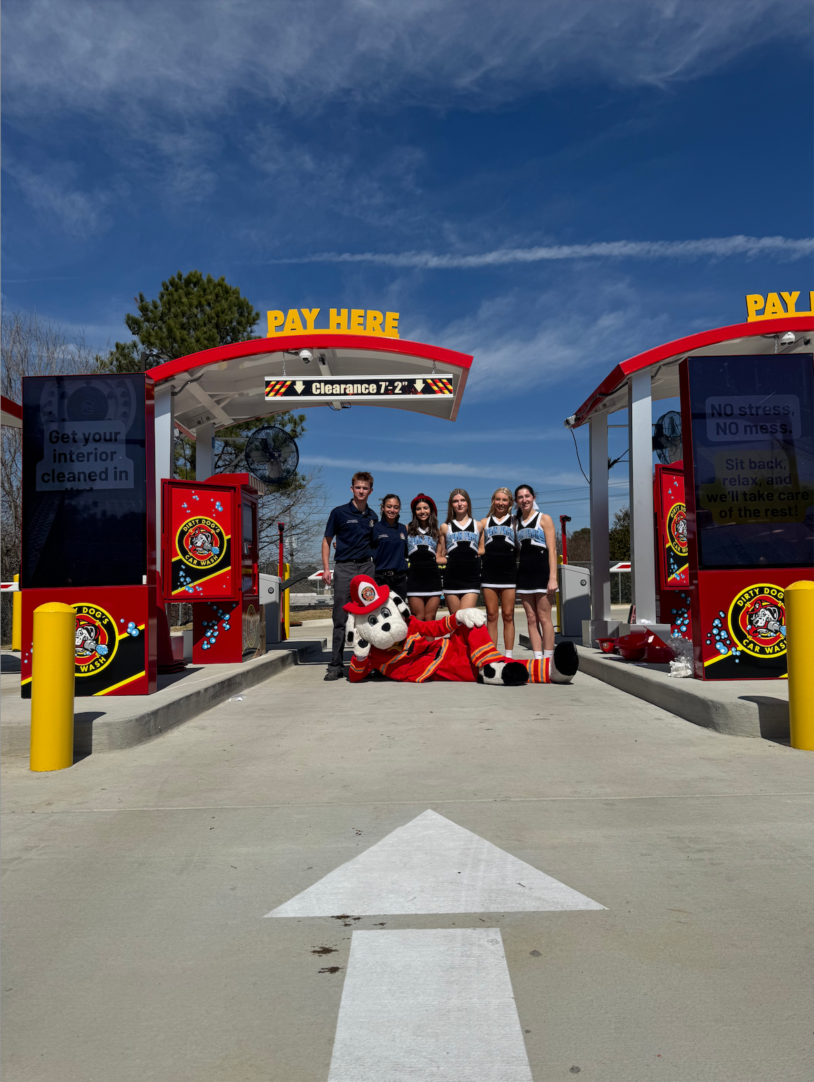 Spain Park Cheer Squad with the Dirty Dog's mascot, Rescue, in the pay station on the Grand Opening Day for the newest Birmingham location. Photo cred: Kayla Diehl
