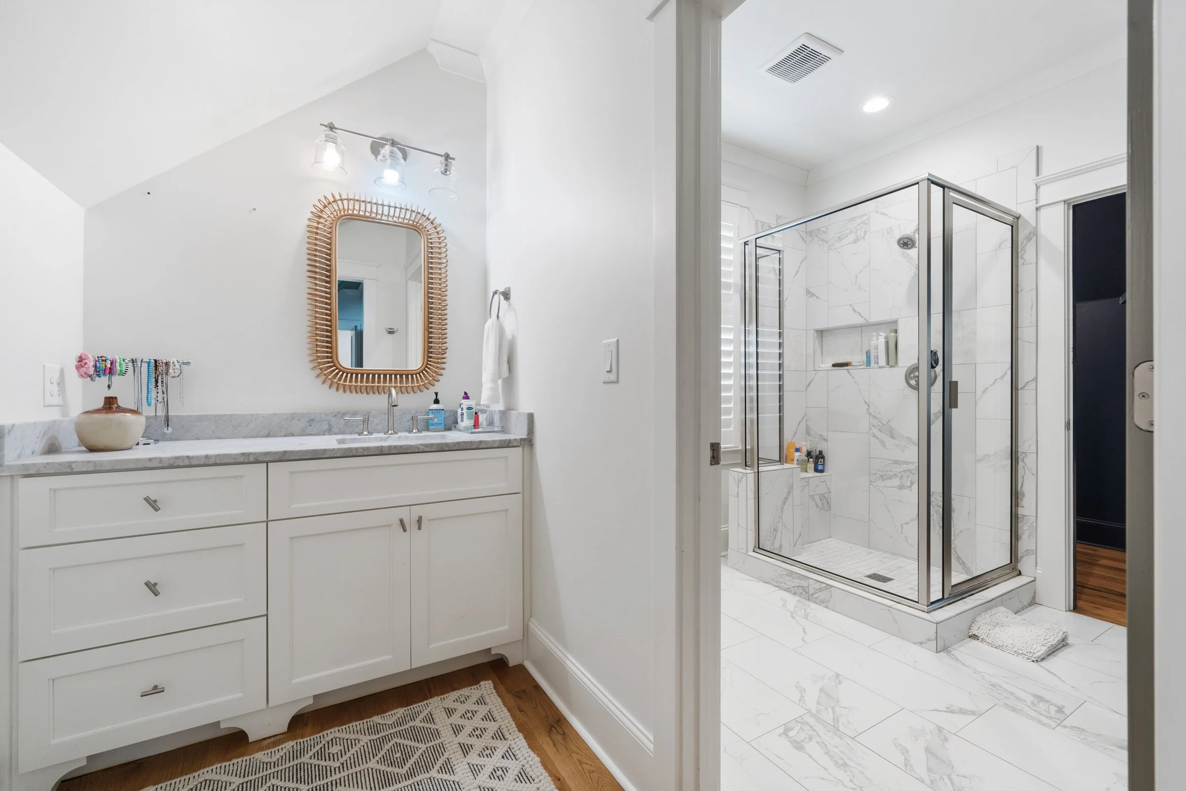 White marble standing shower, with marble countertop sink