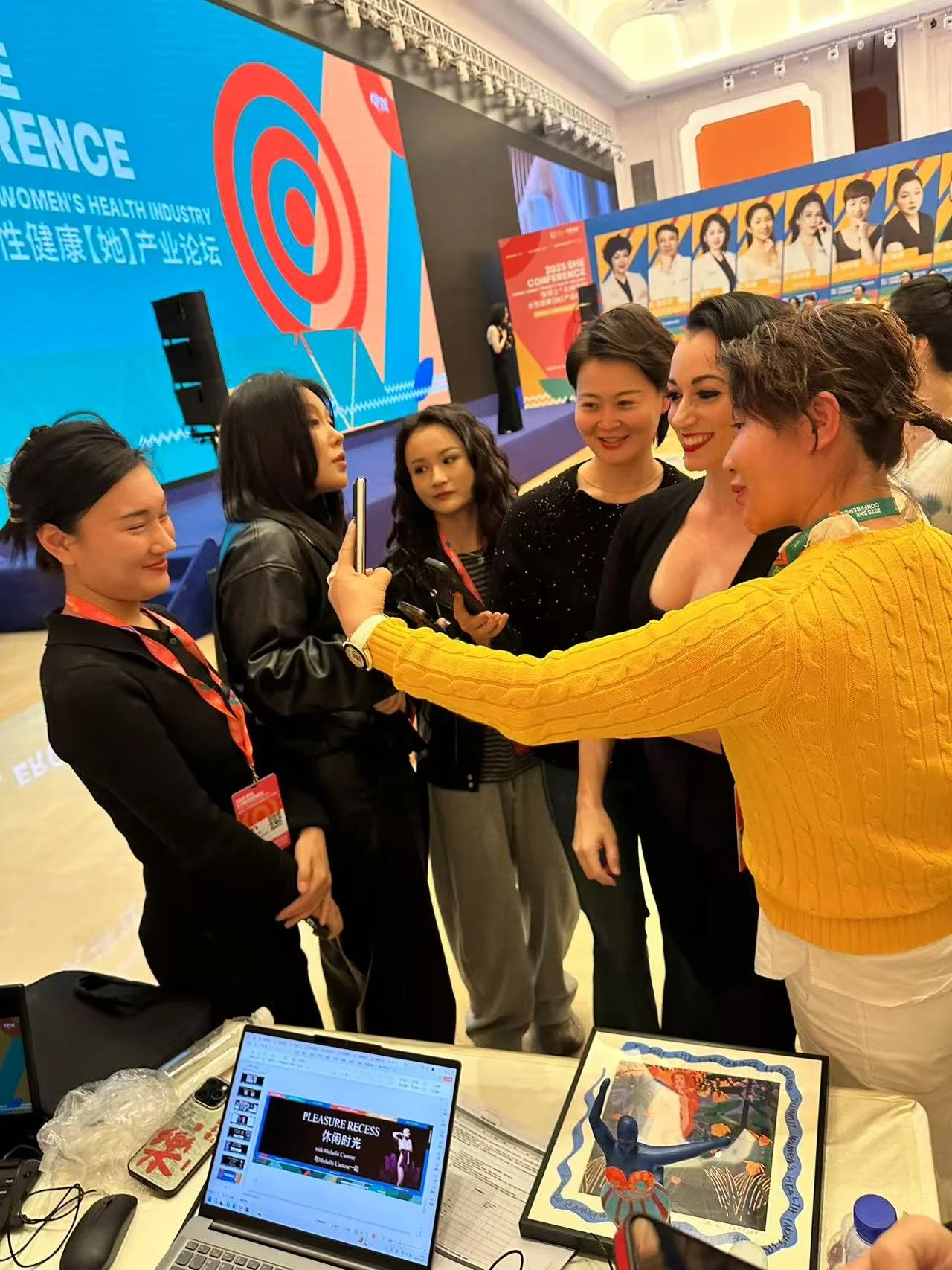 Michelle L'amour greets conference attendees and takes photos with them after her speech