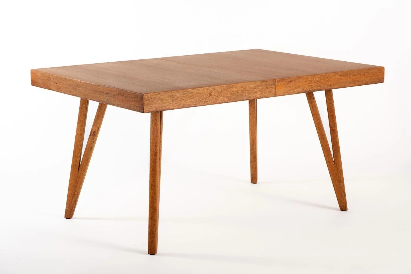 A custom made 1970s mahogany dining table, extendable to seat 8 to 10 people comfortably. Fully restored and smooth as butter, the wood grain alone is enough to stop you in your tracks. It brings serious personality to a room without even trying. The